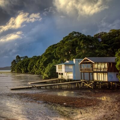 white beach house with dock along the shoreline